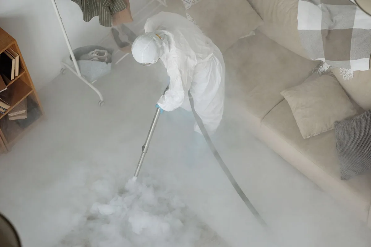Biohazard cleanup technician in protective equipment, Summit, NJ